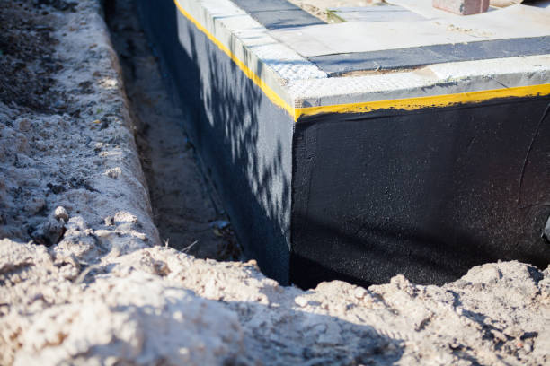 Professional Basement Waterproofing technician working in Stanton, KY